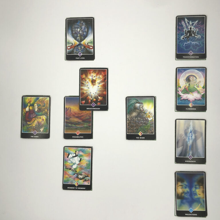 Celtic Cross Layout of daily cards.1 is Now, card is Possibilities.2 is Influence, card is Breakthrough.3 is Goal, card is Past Lives.4 is Distant Past, card is The Miser.5 is Recent Past, card is Moment to Moment.6 is Future Energy, card is The Rebel.7 is Feelings, card is Projections.8 is Others’ views, card is Awareness.9 is Hopes & Fears, card is Flowering.10 is Outcome, card is Transformation.